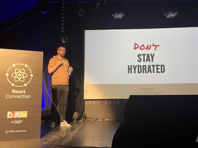 Julian Burr on the stage of React Connection conference