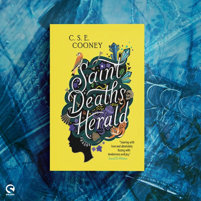 Against a background of blue ice, the cover for SAINT DEATH'S HERALD by C. S. E. Cooney. A bright sunny yellow book cover with the silhouette of a woman's head with different images twined throughout her hair and the title.