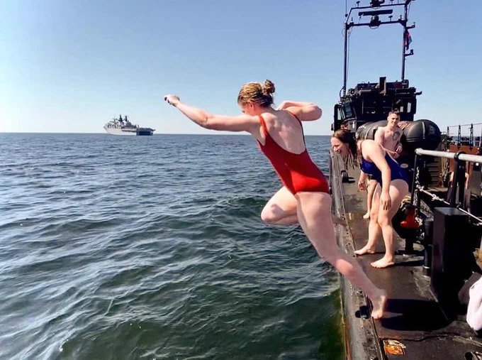 A sailor enjoying hands to bathe-swimming at sea
