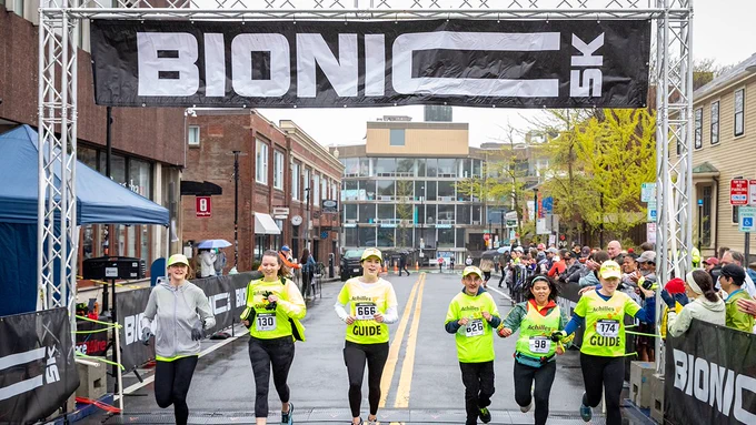 Bionic 5k race participants cross the finish line.
