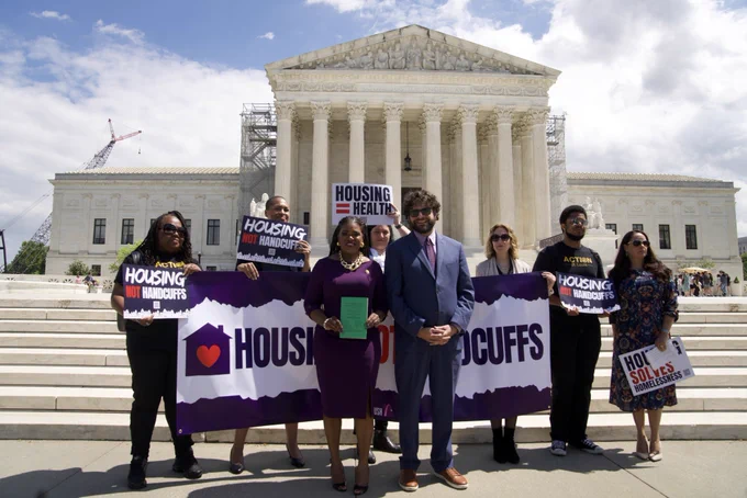The National Homeless Law Center presents Congresswoman Bush with a copy of the Amicus brief they filed jointly