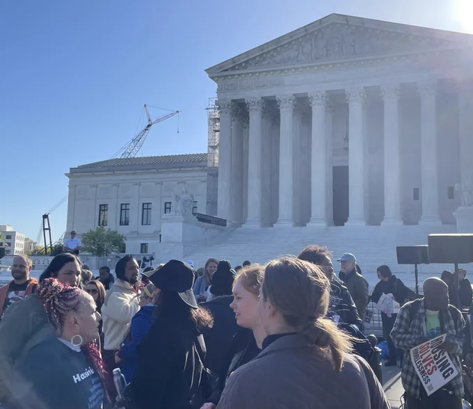 People gathered in front of the Supreme Court in a peaceful rally against ticketing and fining people who are homeless.
