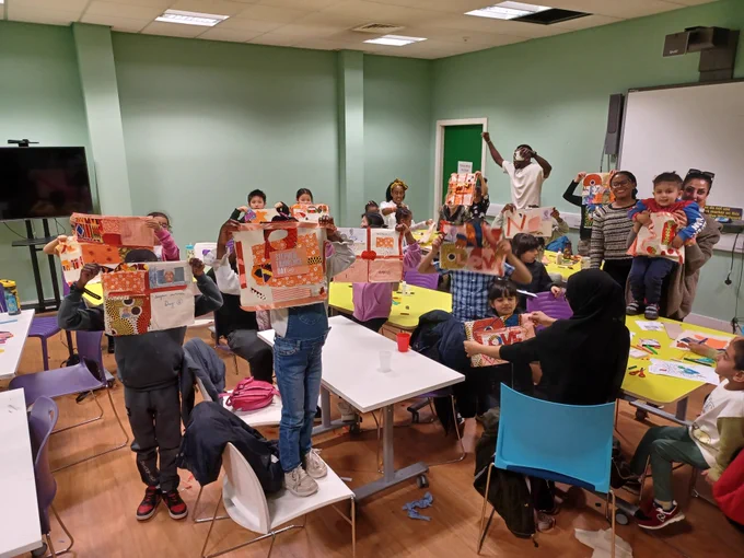 A group of children and Artist Tina Ramos Ekong with their Stephen Lawrence Day banners.