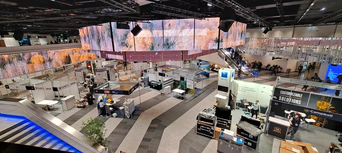 Photo of conference hall with trade stands across the hall