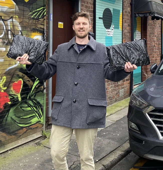 Photo of happy man holding donated devices.