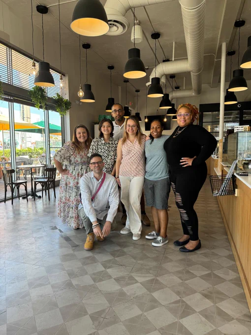 Photo of seven people in cafe