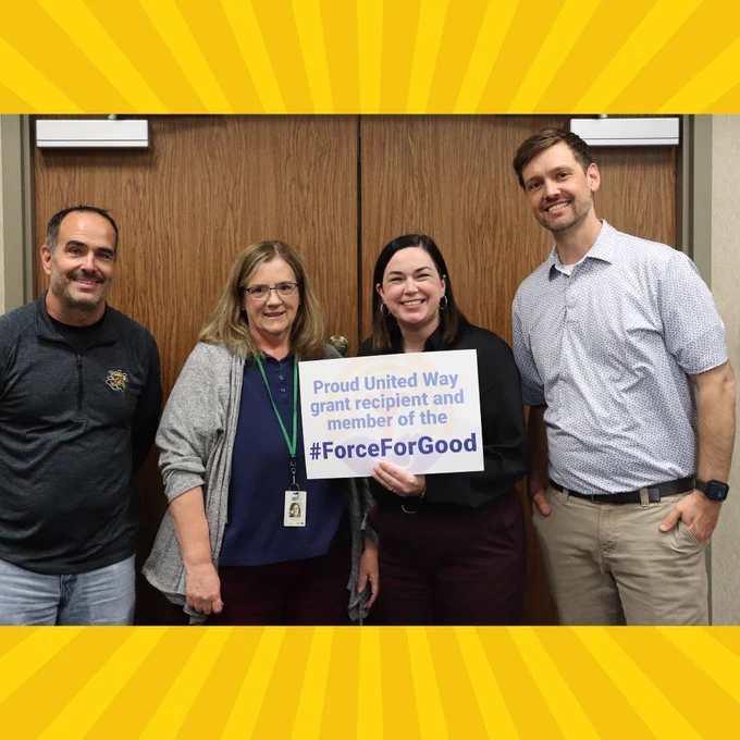 Group photo of CPRF staff, holding a sign that reads, "Proud United Way grant recipient and member of the #ForceForGood".