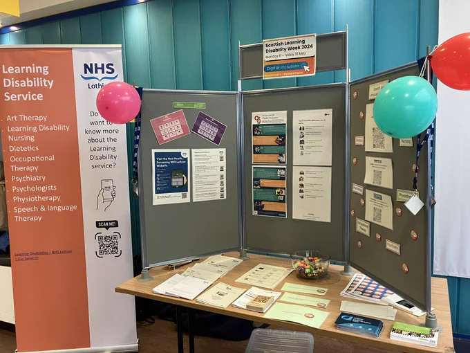 Stall with a banner and notice board with information about learning disability service