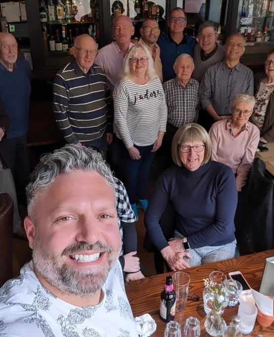 12 Out Together members smiling at camera  at the Adelphi pub in Leeds 