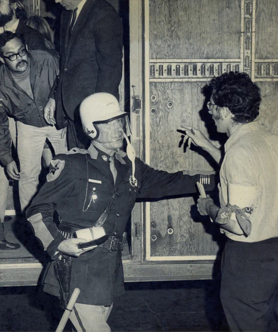 Virginia State Police in riot gear arresting UVA students and loading them into a Mayflower moving truck. May 8 or 9, 1970 (UVA Law Library RG 106-18). 