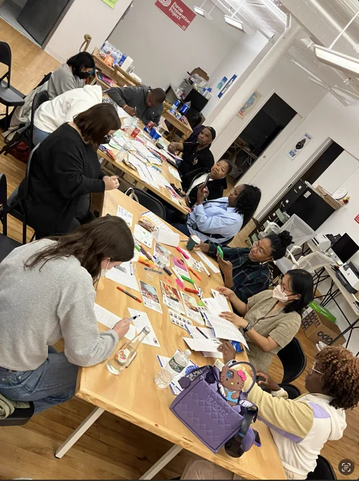 Picture of the crew together writing post cards for clemency.