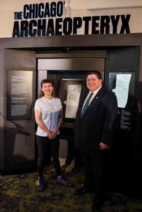 Governor Pritzker poses for a photo with Jingmai O’Connor, the paleornithologist leading the Field Museum’s Archaeopteryx Team.
