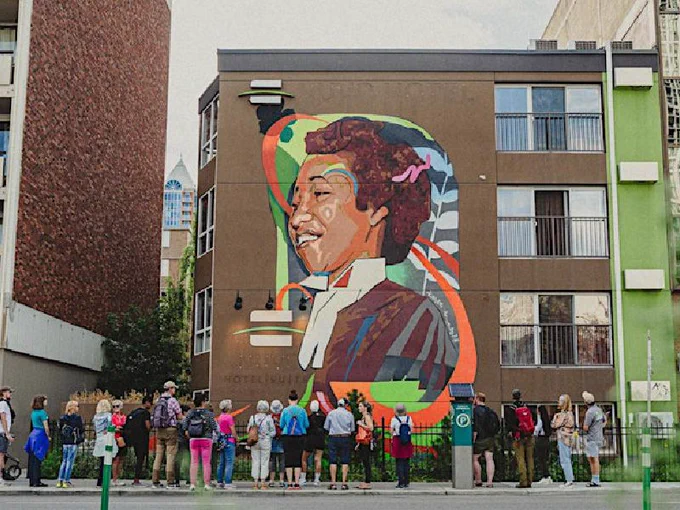 Crowd looking at mural