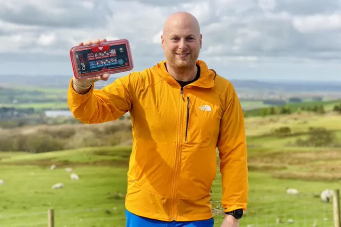Rotarian Christopher Hill overlooking Bolton from Rivington with the pocket-sized CellAED (Image: Bolton Lever Rotary Club)