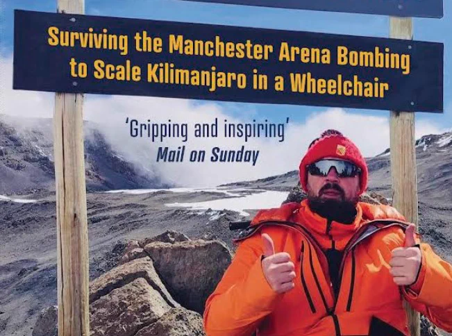 cover of top of the world with Martin Hibbert giving two thumbs up on Mount Kilimanjaro
