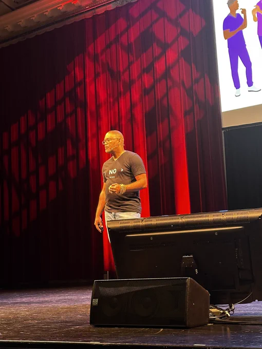 Homer Gaines on stage presenting