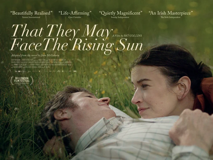 That They May Face the Rising Sun film poster. Close up of male and female lead characters lying in grass, smiling at each other. Quotes include: Beautifully realised. Life-affirming. Quietly magnificent and An Irish masterpiece. 