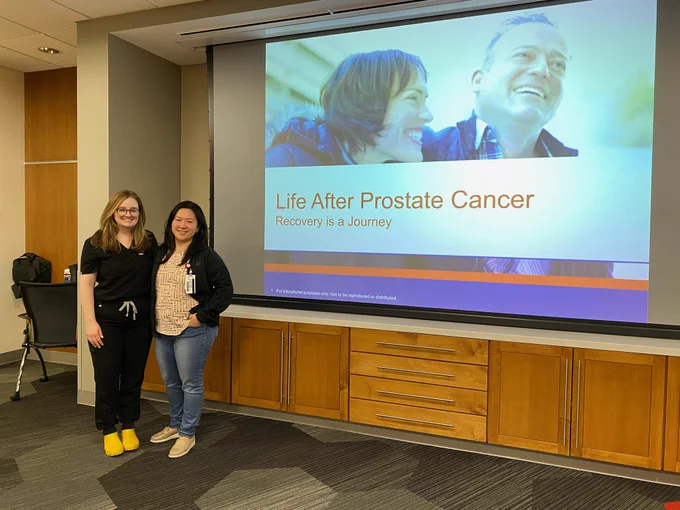 Drs. Sweigert and Yih pose for a photo in front of a PowerPoint (Life After Prostate Cancer)