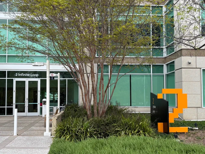 An orange pixelated "2" outside the entrance of 2 Infinite Loop, a building on Apple's Infinite Loop Campus, commonly used to signify years at the company.