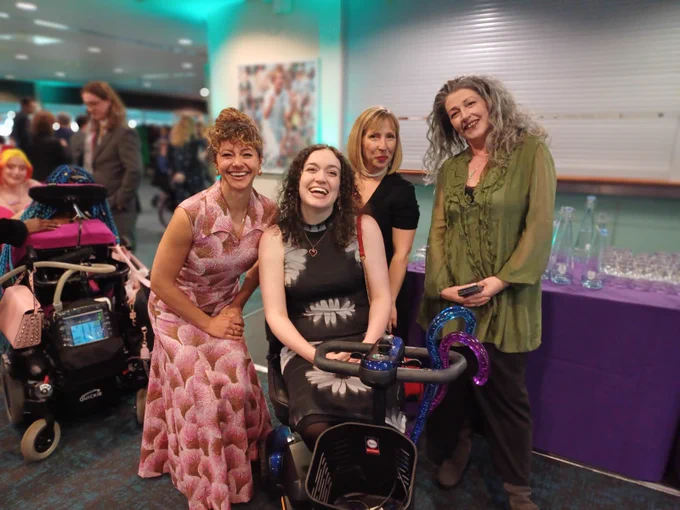 Four glamorous women pose for a photo at an awards ceremony