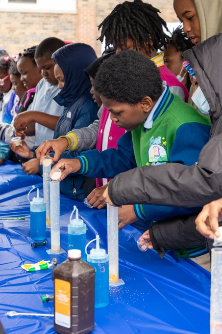 Melody STEM students work on science projects made up of household products 