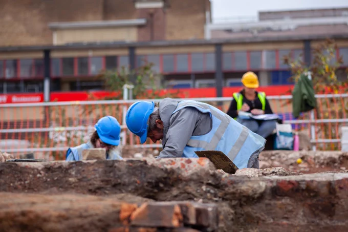 Volunteer digging on the Sheffield Castle site in full PPE in 2018