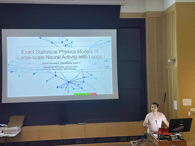 David standing in front of his title slide