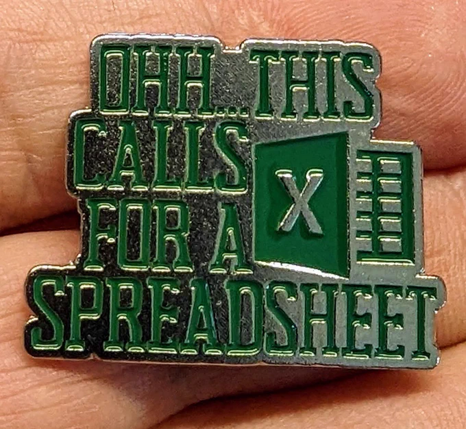 A small green metallic pin with the Excel icon and text that reads “Ohh this calls for a spreadsheet.”