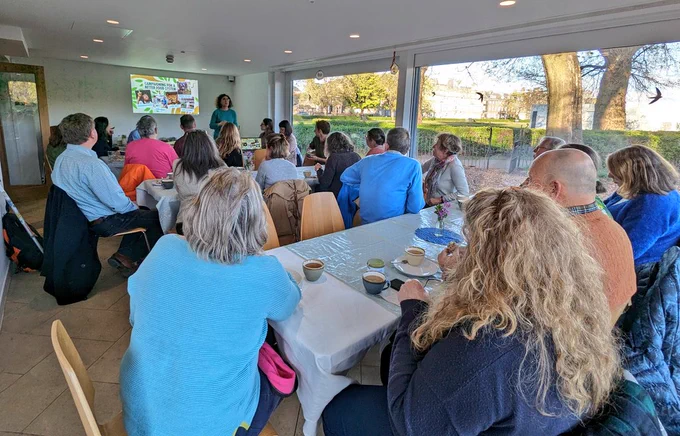 Attendees listening to chairperson Lucia opening the Slow Food Edinburgh AGM at Leith Community Croft.