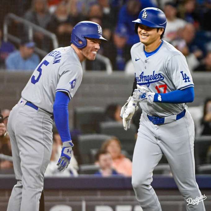 Freddie Freeman and Shohei Ohtani smiles while Shohei runs to the dugout.