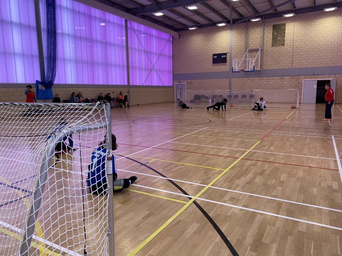 An angle from behind the right goalpost during a goalball game.