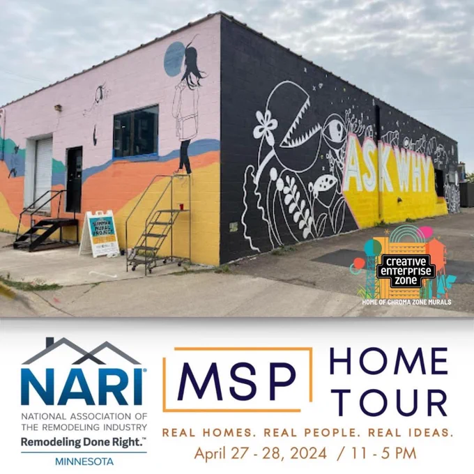 Warehouse building painted on two sides with murals, one says Ask Why