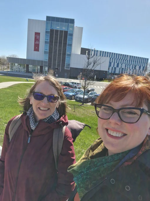Tai and Mary outside uni building smiling