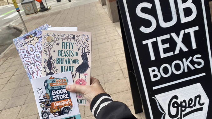 My hand holding the book, and my passport with amazing art by Kevin Cannon