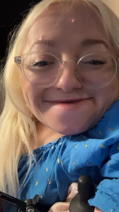 Selfie of gem smiling wearing blue and gold dress