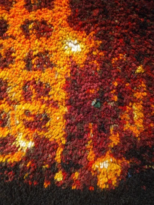 Close-up detail of the Liverpool waterfront rag rug, showing a small section of the Liver Building. Individual knots of the rags are clearly visible.