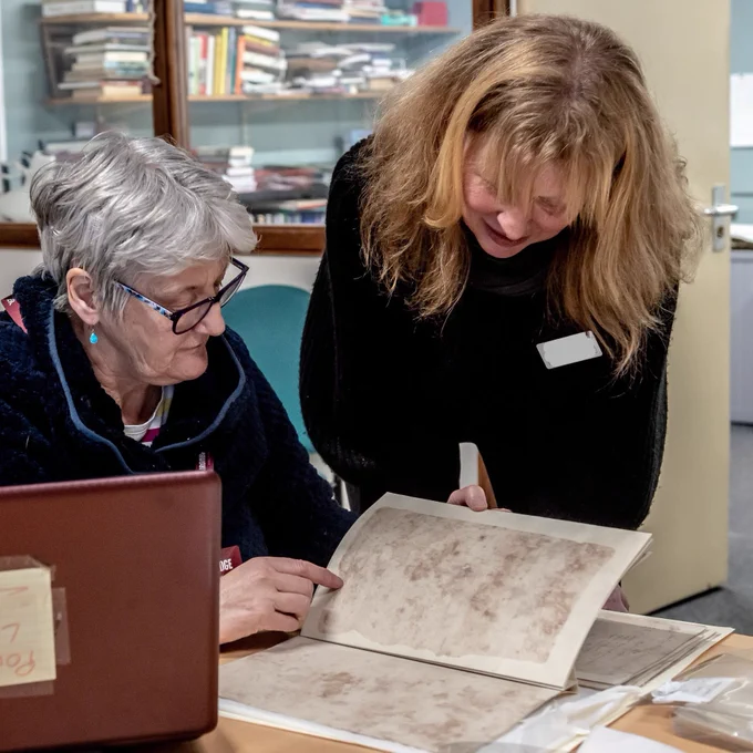 A manager looking at some documents with a team member