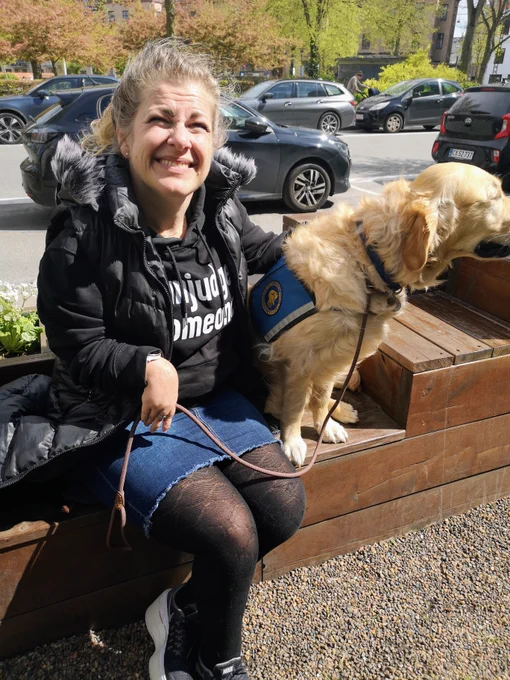 One of our amazing books sitting in the sunshine in the Human Librarys Reading Garden in Copenhagen with her service dog. 
