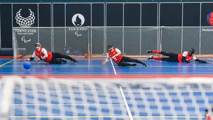 Wide angle shot from behind the goal during a GB training camp showing three of GB Men in the far goal end ready to defend