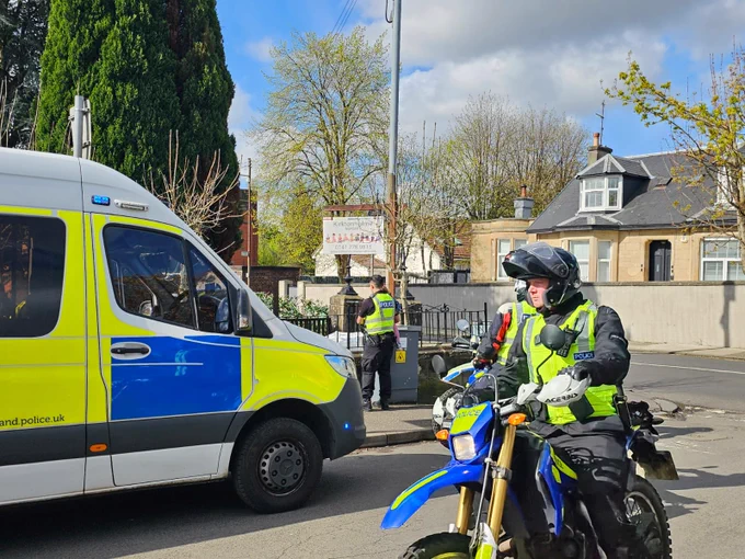 Police van and police motorcyclist outside nursery