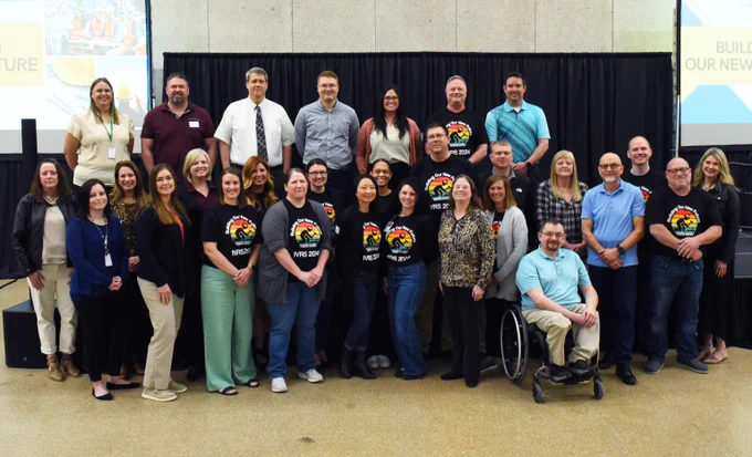 A group photograph of 29 people from the Iowa Vocational Rehabilitation conference in Waterloo, Iowa, on May 1, 2024.  It features leadership from the Vocational Rehabilitation division of Iowa Workforce Development. 
