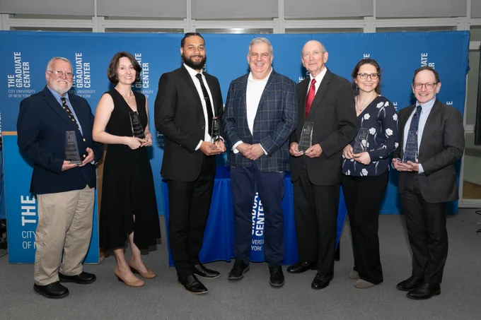Left to right:

Professor Richard Bodnar, Ph.D. ’76, Psychology
Alexandrea J. Ravenelle, Ph.D. ’18, Sociology

Calvin John Smiley, Ph.D. ’14, Sociology
Interim President Josh Brumberg

Roman Popadiuk, Ph.D. ’81, Political Science
Ewa J. Galaj, Ph.D. ’17, Psychology – Neuropsychology
Bill Goldstein, Ph.D. ’10, English