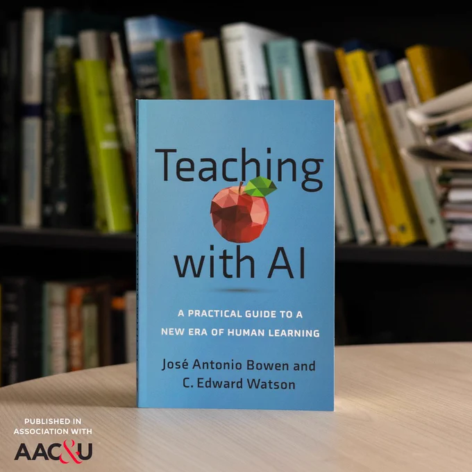 The book "Teaching with AI" on a light wood desk in front of a book shelf. The AAC&U is featured in the lower lefthand corner.