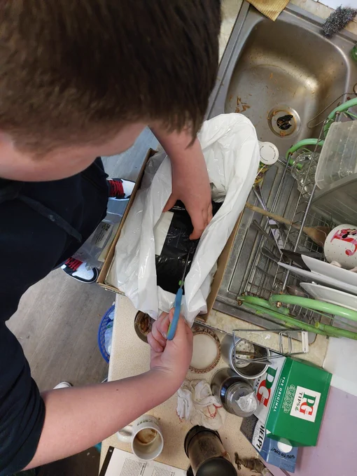 Wrapping the bag of spores and medium up to keep everything cosy and moist.