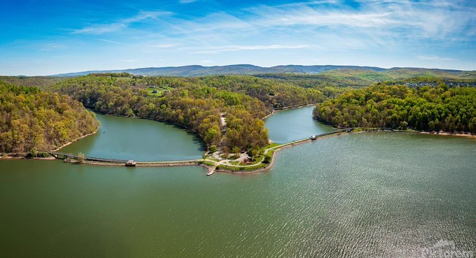 Aerial view as sun casts warm light on the park at Cheat Lake near Morgantown West Virginia on a beautiful calm spring morning