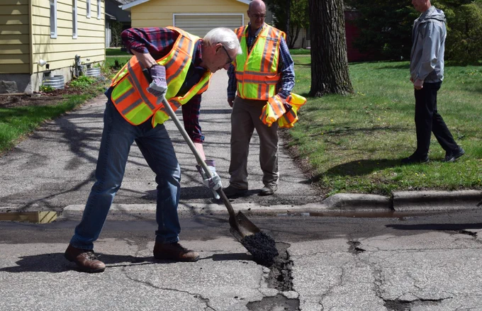 Gov. Evers fills a pothole. 
