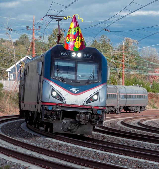 Amtrak locomotive with a birthday hat photoshopped on top of it. 