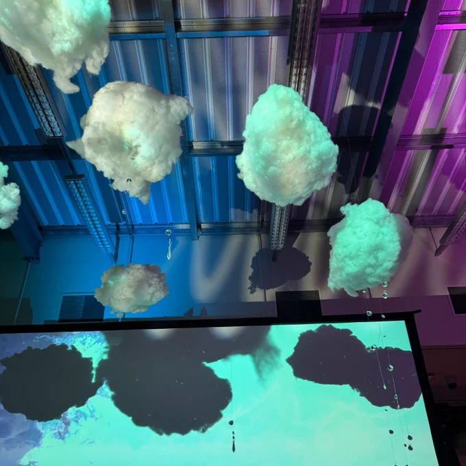 Fluffy clouds don the ceiling of one of the zones in the installation.