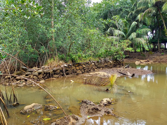 Mangal Abade site from another angle. There are the remnants of a wall in the body of water.