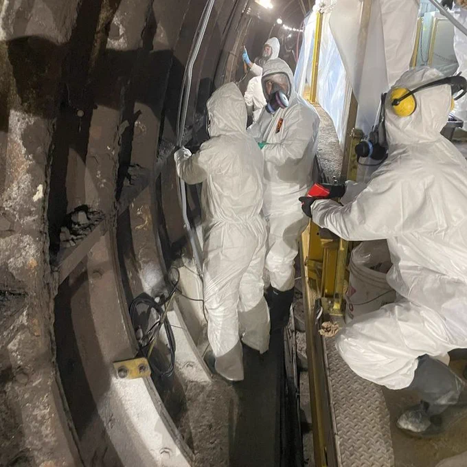 People working in subway tunnel